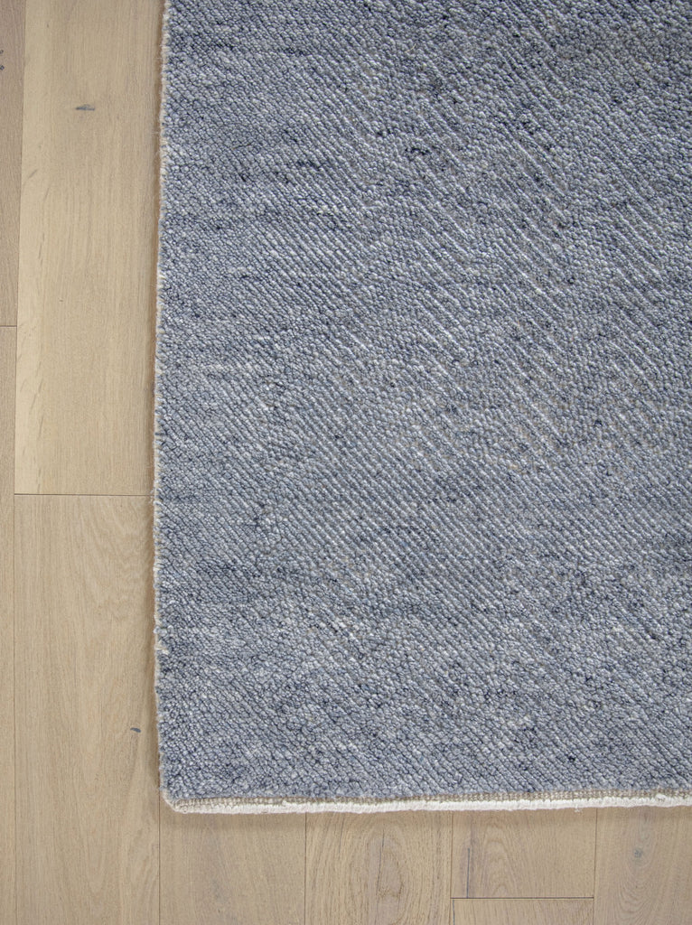 Claire CL-01 Denim Ivory color wool rug with textured pile and solid with hidden with light french oak wood floors by Roya Rugs